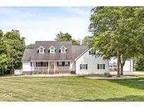 Charming two-story home with a welcoming front porch and a lush, well-manicured lawn at 7221 State Road 42, Martinsville, IN 46151