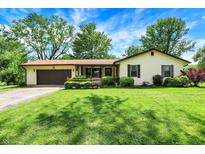 Charming ranch home with a well-manicured lawn, attached garage, and inviting front porch at 101 Heiny Rd, Indianapolis, IN 46217