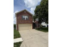 Two-story brick home with a two-car garage and a basketball hoop in the driveway at 10194 Lothbury Cir, Fishers, IN 46037