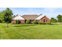 Charming brick home with a well-manicured lawn and mature trees, perfect curb appeal at 1607 Michelle Manor, Danville, IN 46122