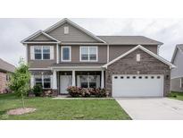 Charming two-story home with brown siding, brick accents, white trim, and an attached two-car garage at 1661 Devonshire Ave, Avon, IN 46123