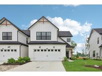 Charming two-story home features a white facade, attached garage, and well-manicured lawn at 17551 Gruner Way, Westfield, IN 46062