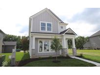 Charming two-story home features board and batten siding, stone accents and a well-manicured lawn at 1813 Real St, Indianapolis, IN 46240