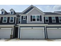 Charming two-story townhouse featuring gray siding, black shutters, and a spacious two-car garage at 18736 Moray St, Westfield, IN 46074