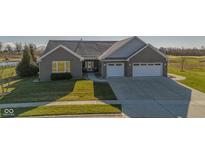 Beautifully landscaped brick home with a two-car garage and view of the golf course at 201 St Andrews Ave, Edinburgh, IN 46124