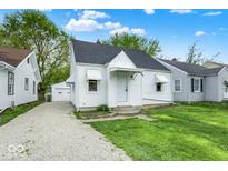 Charming home featuring a well-maintained front yard and a gravel driveway at 2015 S Hackley St, Muncie, IN 47302