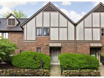 Charming brick townhouse featuring a meticulously landscaped front yard, enhancing its curb appeal at 2263 Rome Dr, Indianapolis, IN 46228