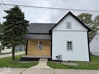 Charming two-story home with mixed siding and a well-maintained front yard on an overcast day at 317 W Pierson St, Greenfield, IN 46140