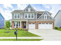 Beautiful two-story home featuring a brick facade, gray siding, a well-manicured lawn, and a two car garage at 3667 Gilmore Pl, Bargersville, IN 46106