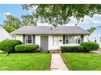 Charming single-story home featuring a well-maintained lawn and manicured shrubs at 4751 Payton Ave, Lawrence, IN 46226