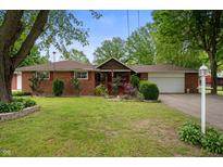 Charming red brick ranch-style home with manicured lawn and attached garage at 5092 S 50 W, Anderson, IN 46013