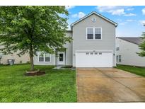 Charming two-story home with well-maintained lawn and a two car garage at 630 Harmony Way, Greenwood, IN 46143