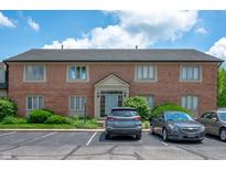 Brick building exterior featuring manicured landscaping and convenient parking at 8503 Canterbury W Sq # D, Indianapolis, IN 46260
