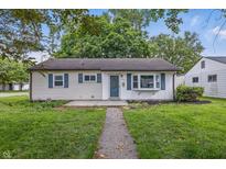 Charming home with blue shutters, a well-manicured lawn, and a welcoming walkway to the front door at 903 Sunset Dr, Lebanon, IN 46052