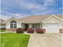 Charming ranch home featuring a manicured lawn, covered porch and attached garage at 1108 Northfield Ln, Anderson, IN 46011