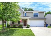 Charming two-story home featuring a well-maintained lawn, an attached garage, and tasteful landscaping at 11437 High Grass Dr, Indianapolis, IN 46235