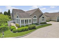 Beautiful home exterior boasts stone accents, manicured landscaping, and ample natural light at 1146 Distinctive Way, Greenfield, IN 46140