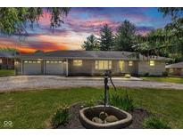 Charming one-story home with stone facade, two-car garage, and well-maintained front yard at 132 S First St, Jamestown, IN 46147