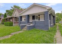 Charming bungalow featuring a covered front porch with detailed columns and a cozy entrance at 1411 N Grant Ave, Indianapolis, IN 46201