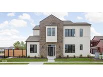 Beautiful home featuring a mixed material facade of siding and brick, green lawn and professionally landscaped flower beds at 1675 Solebar Way, Westfield, IN 46074