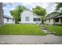 Charming home with a lush green lawn and inviting front entrance with concrete steps at 2012 George St, Anderson, IN 46016