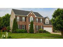 Charming two-story brick home with black shutters, manicured lawn, and attached two-car garage at 2233 Burgundy Way, Plainfield, IN 46168