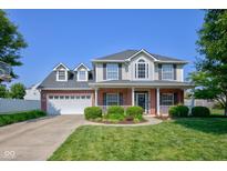 Charming two-story brick home with a well-maintained lawn and attached two-car garage at 2234 Burgundy Way, Plainfield, IN 46168