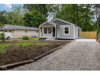 Charming home with a gravel driveway and freshly seeded lawn at 3614 N Whittier Pl, Indianapolis, IN 46218
