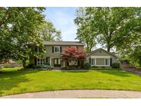 Charming two-story home with lush green lawn and mature trees, creating a welcoming curb appeal at 3713 Coventry Way, Carmel, IN 46033