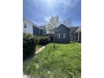 Charming single-Gathering home with a walkway and a cozy, welcoming front yard at 409 Parkway Ave, Indianapolis, IN 46225