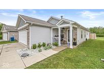 Charming single-story home with a cozy front porch and well-maintained landscaping, plus an attached garage at 4167 Apple Creek Dr, Indianapolis, IN 46235