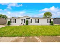 Charming single-story home with a well-manicured lawn and classic white siding at 4640 Autumn Ridge Dr, Columbus, IN 47203