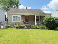 Charming single-story home with a well-manicured lawn and a cozy front porch at 4853 Wentworth Blvd, Indianapolis, IN 46201
