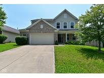 Charming two-story home with a brick and vinyl facade, a two-car garage, and a well-maintained lawn at 5151 Climbing Rose Pl, Indianapolis, IN 46254