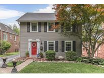 Charming two-story home featuring a red front door, black shutters, and a well-manicured lawn at 5306 N Kenwood Ave, Indianapolis, IN 46208
