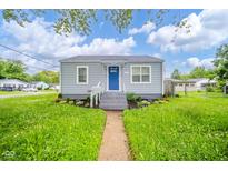 Charming single-story home with a bright blue door, landscaped front yard, and inviting curb appeal at 564 S Bosart Ave, Indianapolis, IN 46203