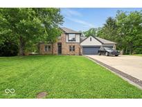 Charming two-story home with a brick facade, well-manicured lawn, and attached two-car garage at 6396 Granny Smith Ln, Avon, IN 46123