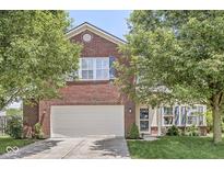 Charming two-story brick home featuring an attached garage and a well-maintained front yard at 671 Sonoma Ln, Greenfield, IN 46140