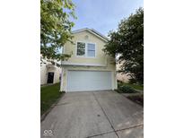 Charming two-story home featuring an attached two-car garage and mature trees at 6744 Redan Dr, Indianapolis, IN 46254