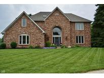 Charming two-story brick home with a well-manicured lawn and beautiful landscaping at 6862 Riverside Way, Fishers, IN 46038