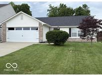 Charming home featuring a two-car garage, well-kept lawn, and inviting curb appeal at 7022 Cordova Dr, Indianapolis, IN 46221