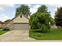 Charming home featuring a two-car garage, well-manicured lawn, and mature landscaping at 842 Cheltenham Way, Avon, IN 46123