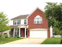 Charming two-story home featuring a brick facade, two-car garage, and well-maintained front lawn at 8519 Frosty Rose Dr, Avon, IN 46123