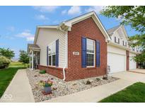 Charming home showcasing brick and vinyl siding, complemented by blue shutters and manicured landscaping at 9682 Angelica Dr, Noblesville, IN 46060