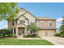 Traditional brick home boasting attached three car garage and professionally landscaped yard at 9833 Parkshore Dr, Fishers, IN 46038