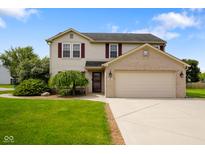 Charming two-story home featuring a two-car garage, well-maintained lawn, and beautiful landscaping at 101 Meadowview Dr, Mooresville, IN 46158