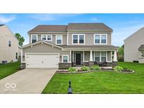 Charming two-story home with manicured lawn and inviting front porch at 10515 Sugar Ridge Way, Indianapolis, IN 46239