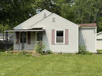 Charming single-story home with an iron-railed porch and light-colored siding at 11026 N Kitchen Rd, Mooresville, IN 46158