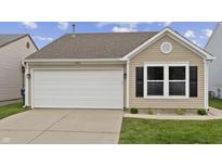 Charming home featuring a garage, well-manicured lawn, and a classic window design at 1313 Kenwood Dr, Greenwood, IN 46143
