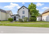 Charming home featuring a white exterior with black trim and a well-manicured lawn at 2111 S A St, Elwood, IN 46036